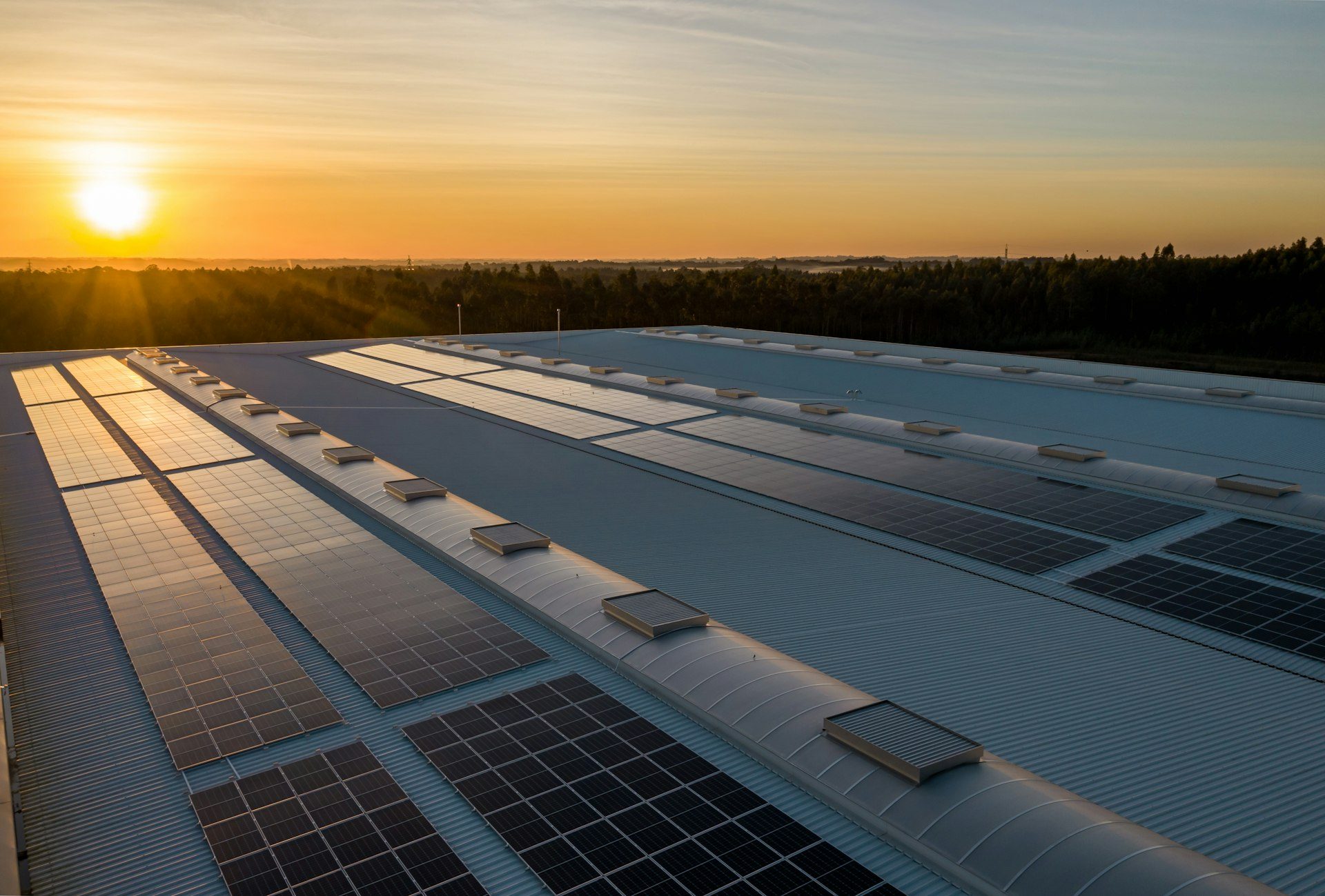 Commercial rooftop solar array at sunset