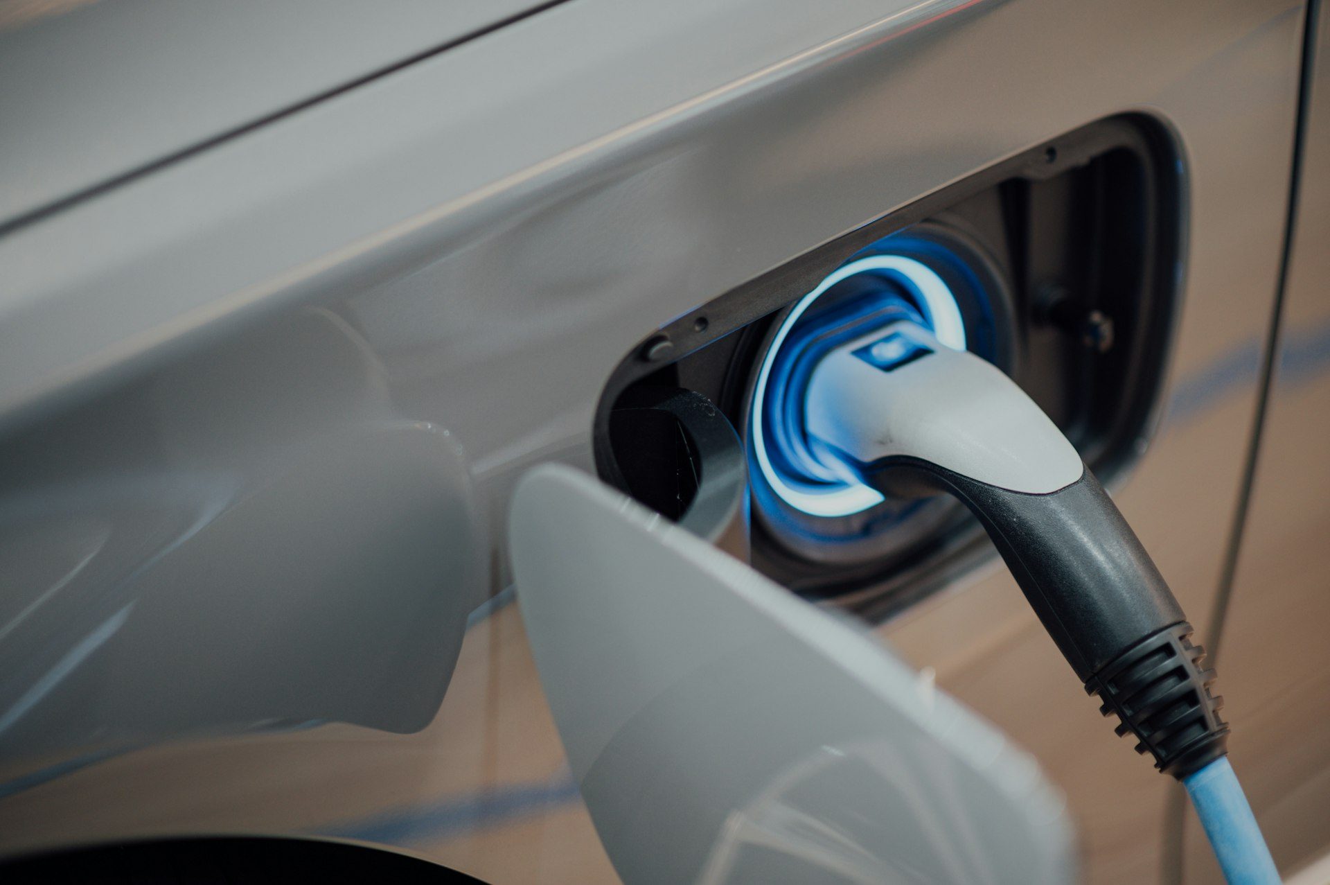 Electric vehicle plugged in to a charger