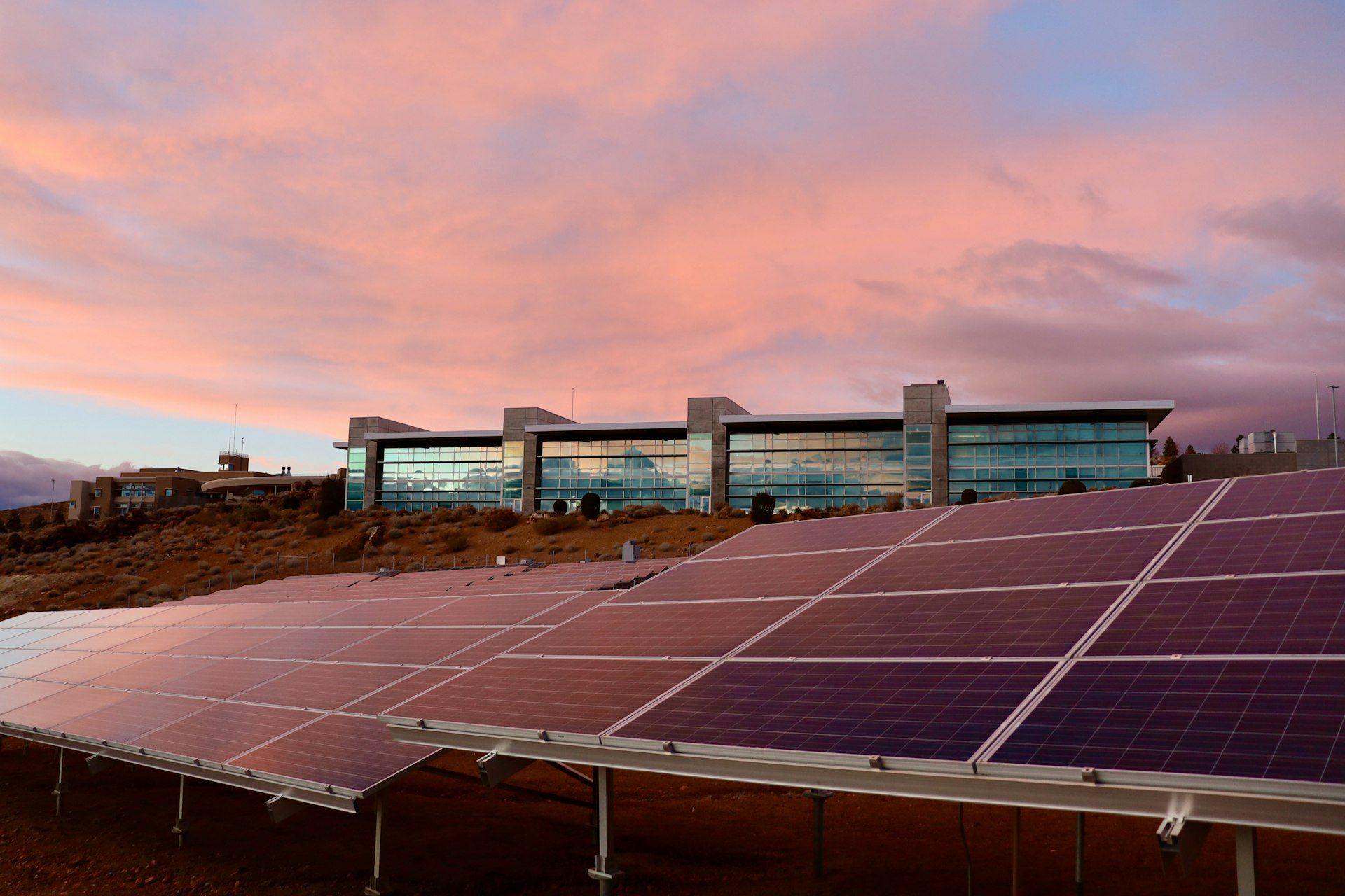 Large commercial solar installation on a flat roof at dusk